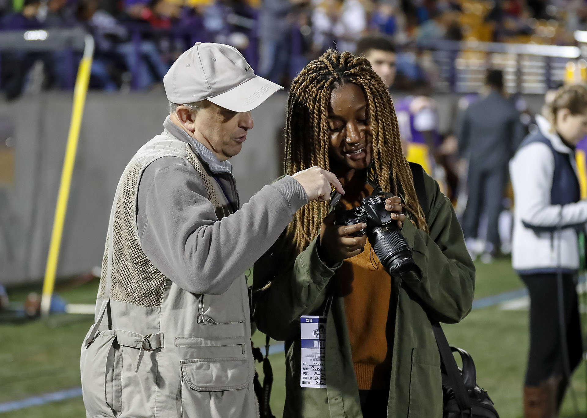 Communication student photographing a sporting event