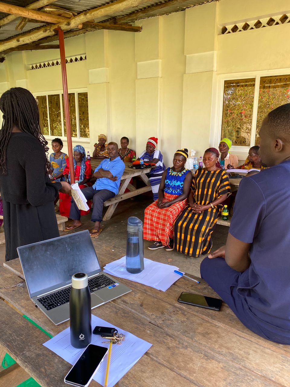Zari Ward stands in front of a group of village health workers.