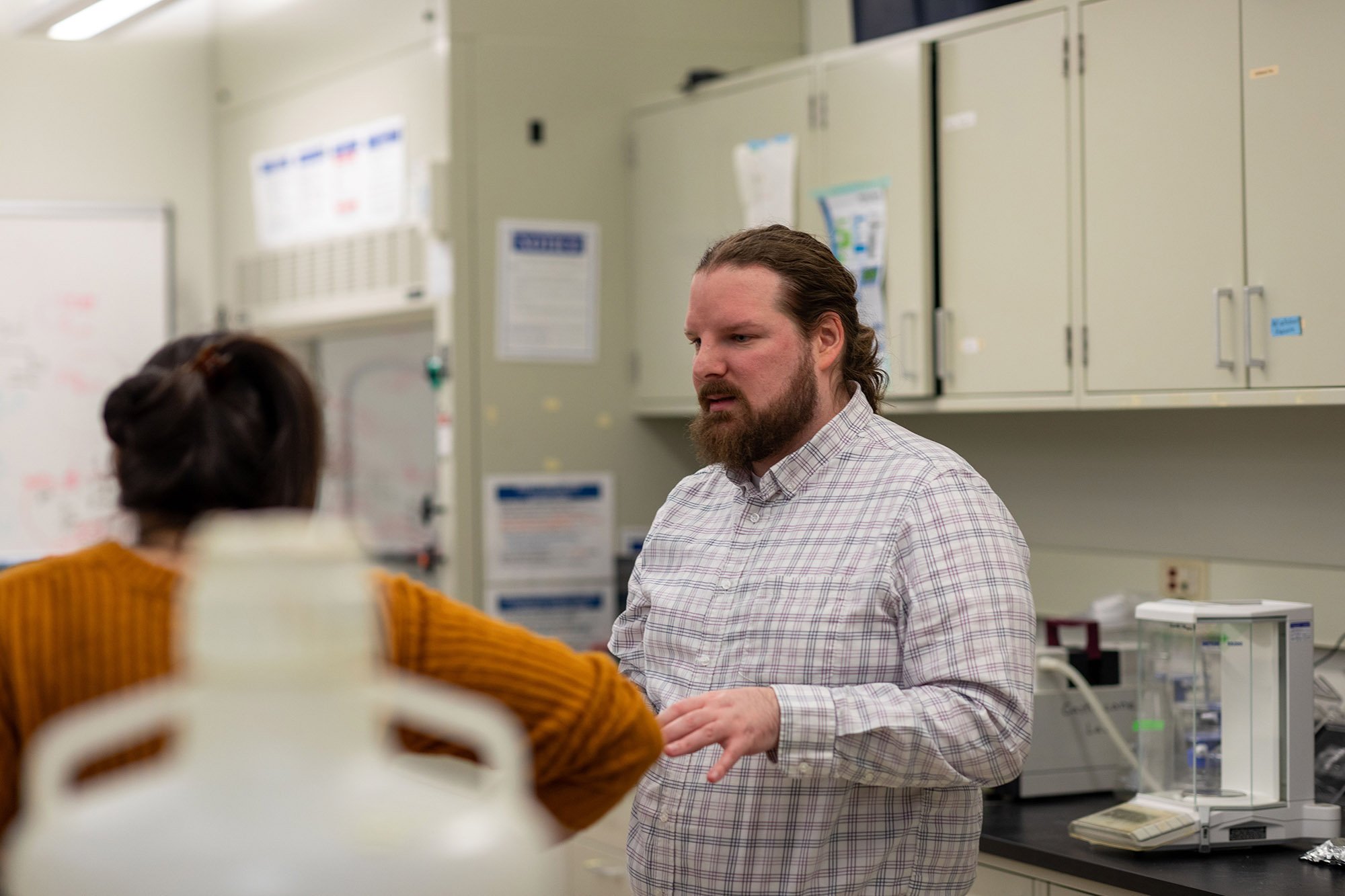 UAlbany PhD student Michael Dolan smiles inside the lab of Associate Professor Mike Fasullo