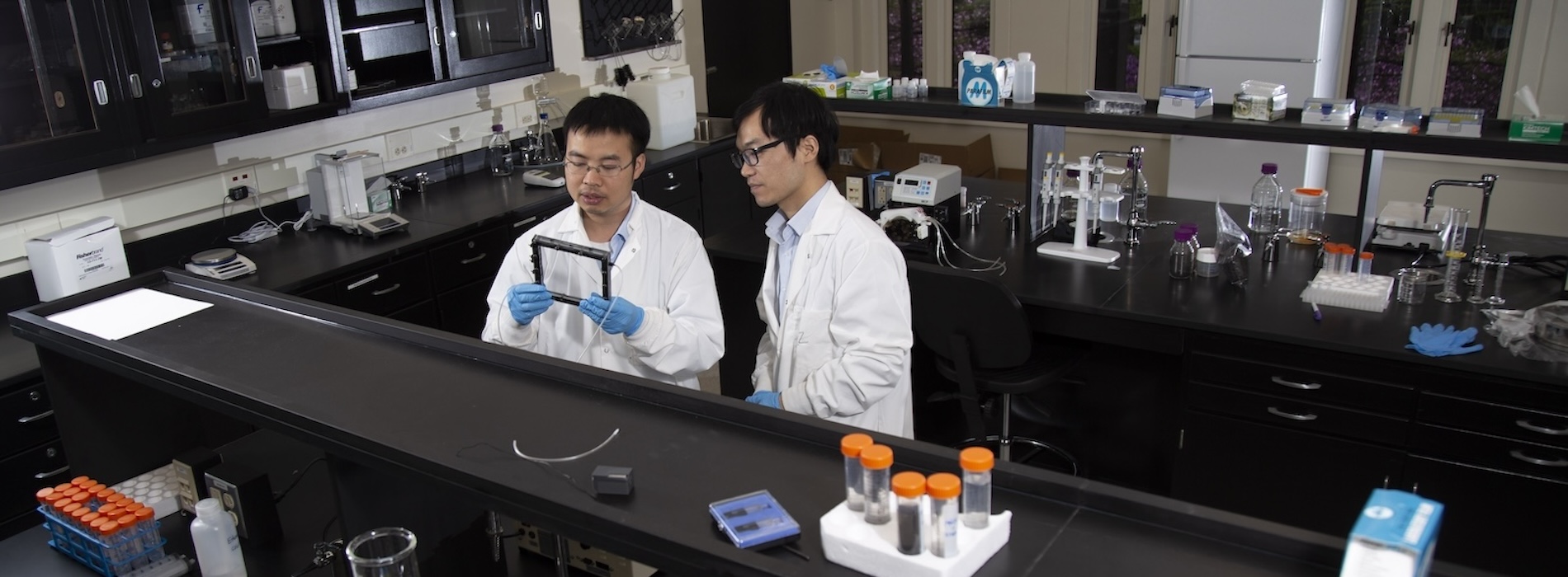 Two researchers talking in ESE Biology Lab