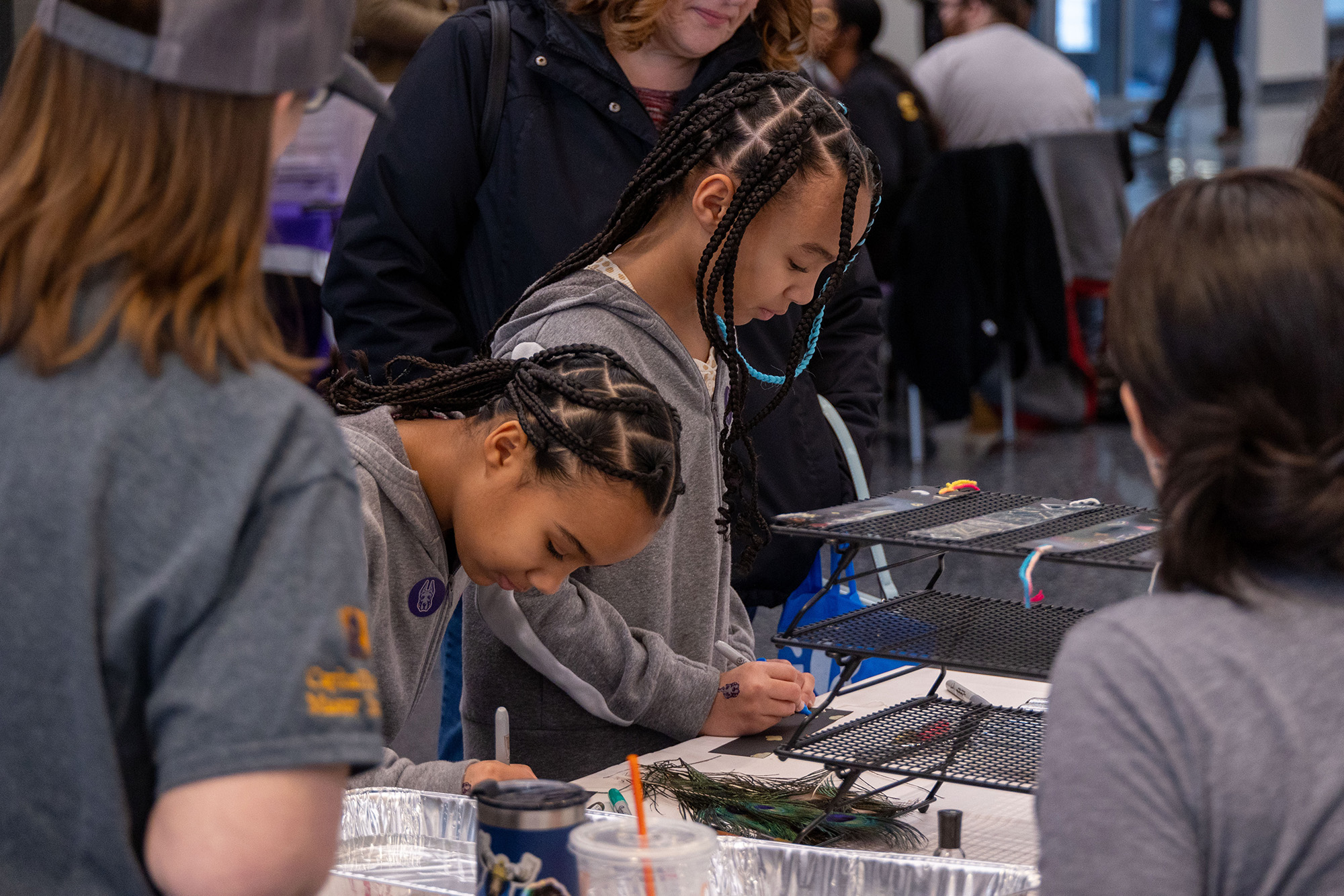 Two young students explore a table-top science experiment at STEM and Nanotechnology Family Day at UAlbany on Feb. 10, 2024.