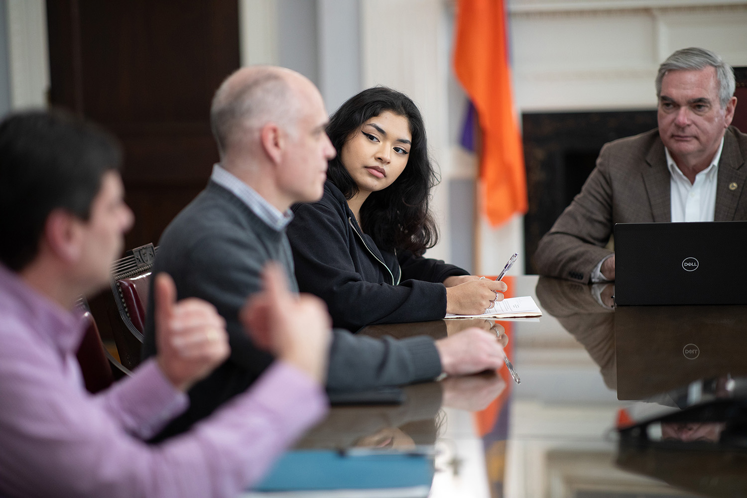 UAlbany mathematics major Michelle Leon Vasquez listens to Brian Burke discusss the community asset tracker project in a meeting room at Schenectady City Hall.