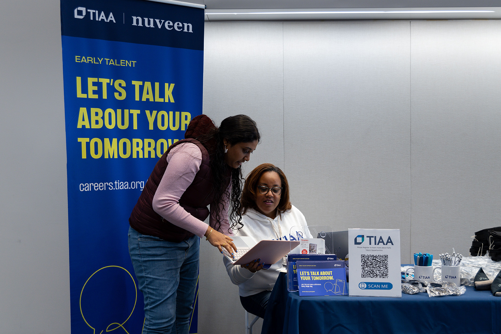 A student holds a laptop during a meeting with TIAA's Laurie Brown-Goodwine at the State of Grace Conference.