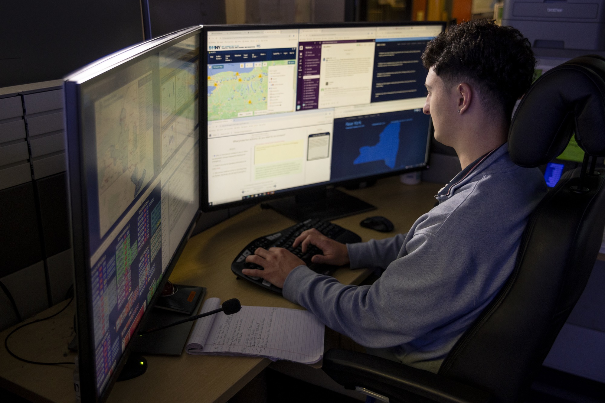 A student looks at dual monitors from inside the Emergency and Risk Communication Message Testing lab at ETEC.