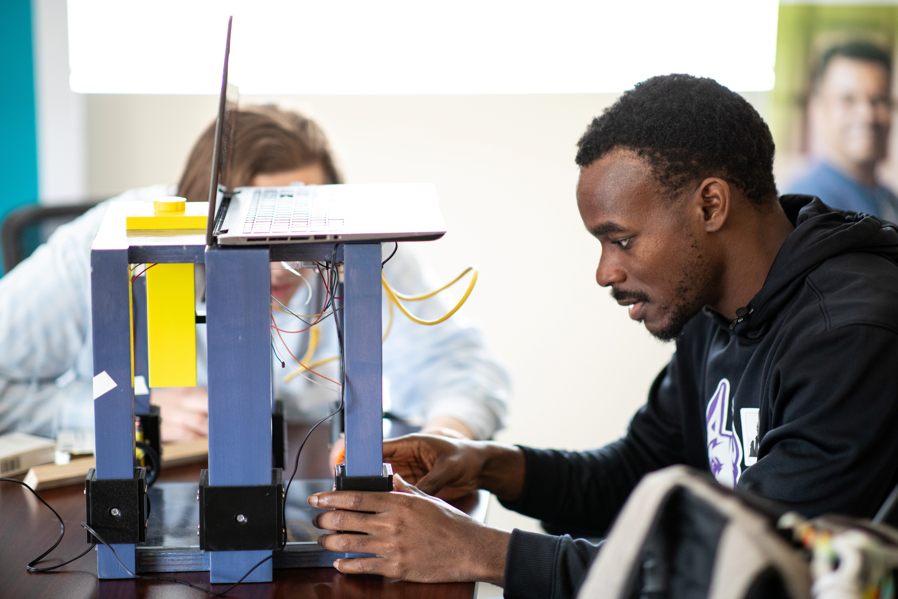 Senior Shak Williams works on a device to assist workers living with disabilities for the New York State Industries for the Disabled. (Photo by Patrick Dodson)