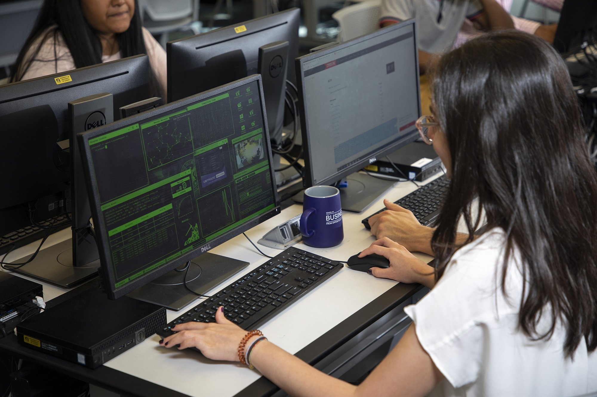 A student works at a terminal in the Digital Forensics lab at the Massry School of Business. (Photo by Patrick Dodson)