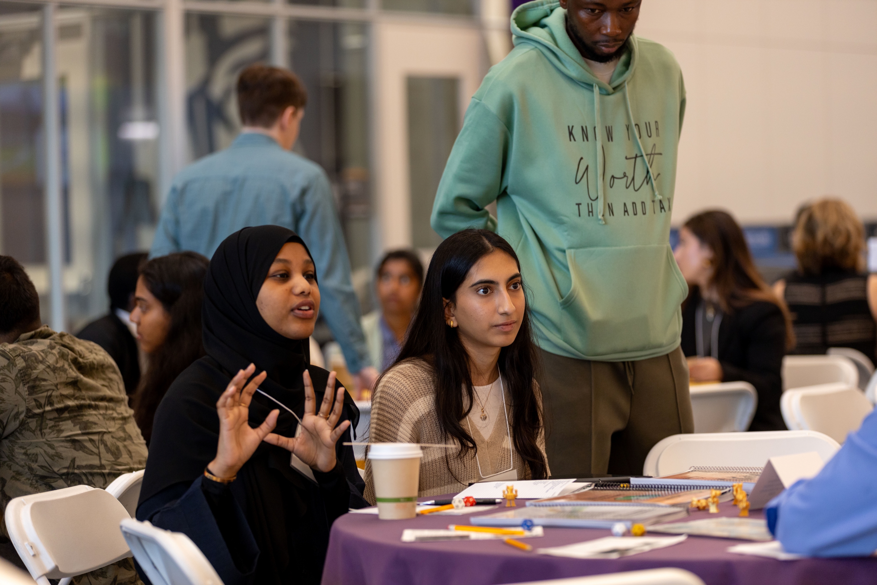 Two students engage in conversation during Research and Entrepreneurship Week at UAlbany in October, 2024. (Photo by Mario Sotomayor)