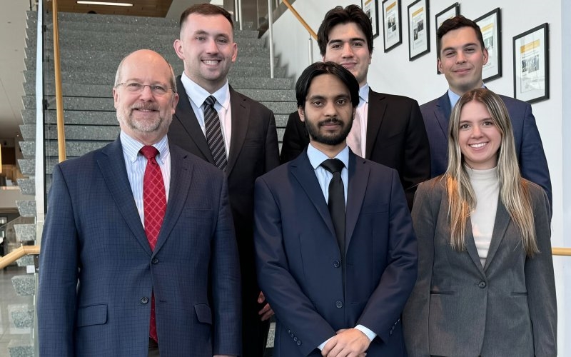 Students from UAlbany's CFA challenge team that advanced to the Americas-Region finals stand with Massry School of Business Professor and Chair of Finance David Smith. (Photo provided)