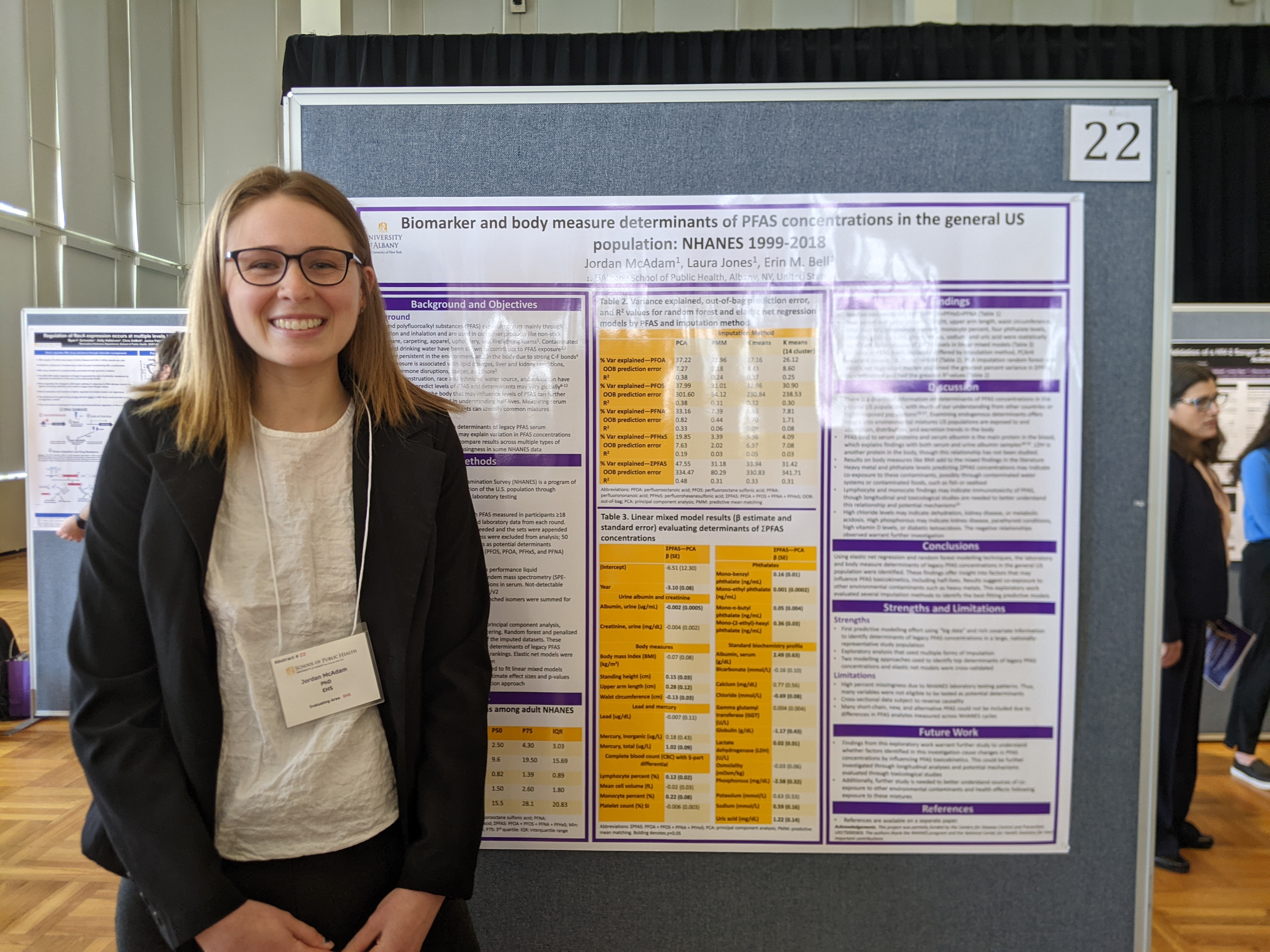 Jordan McAdam stands in front of her poster at Poster Day.