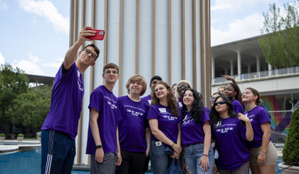 Students from a living and learning community taking a selfie together by the fountain