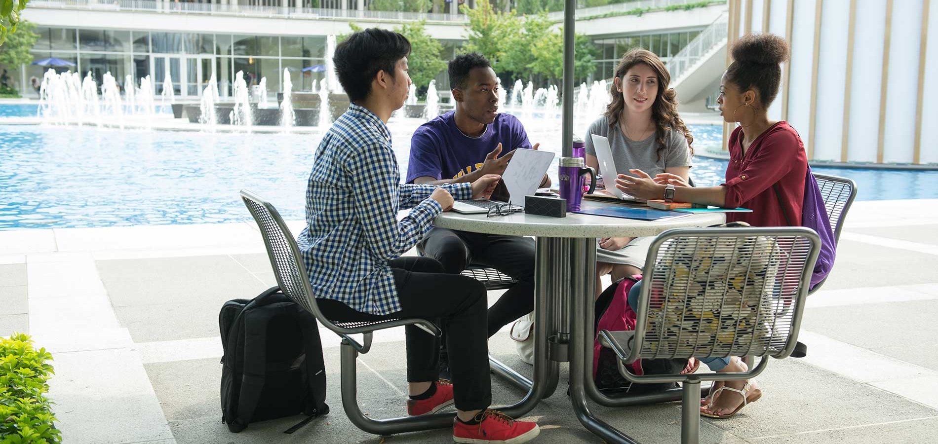 Four students sitting at a table together