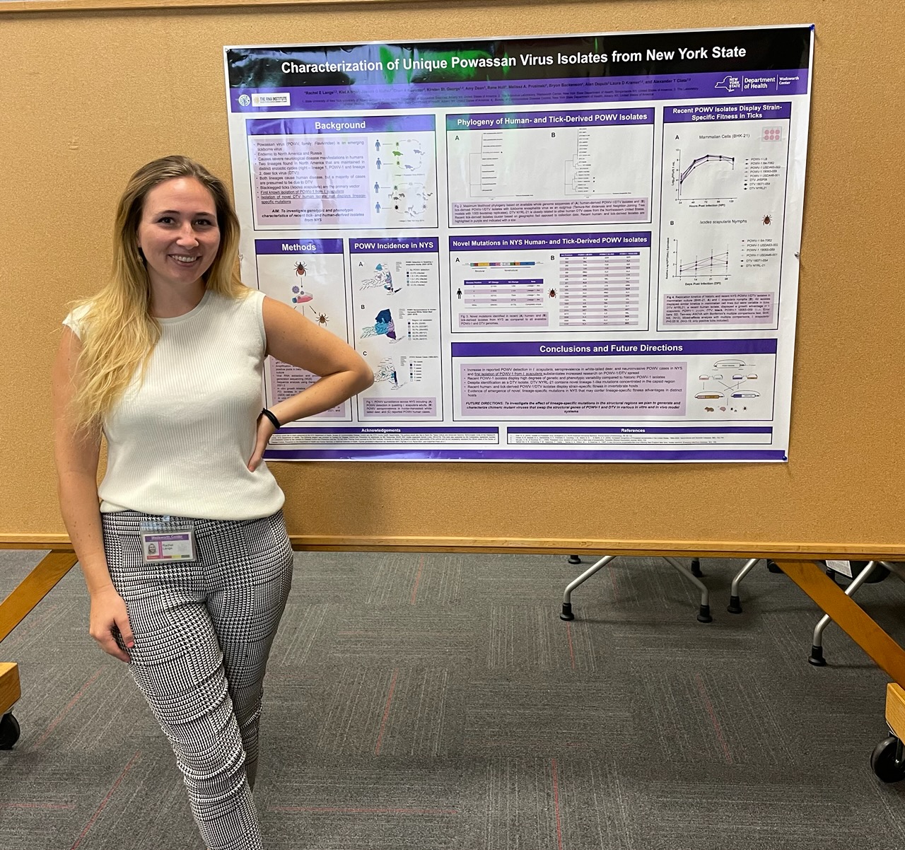 Rachel Lange stands in front of an academic poster.