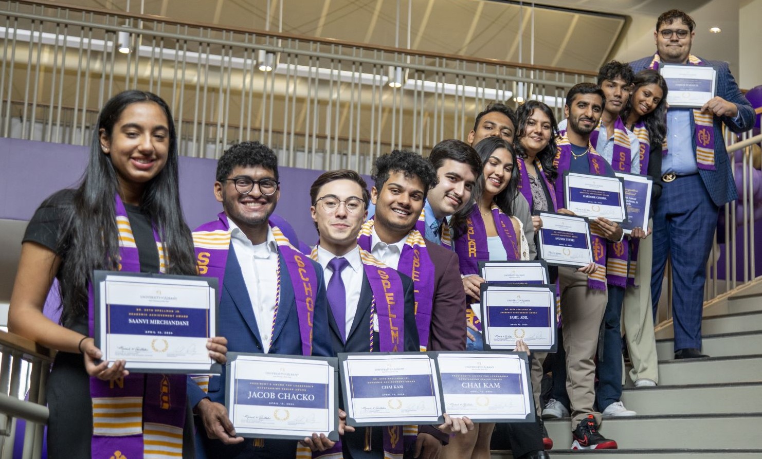 2024 Spellman Award winners standing together proudly showing their award certificates.