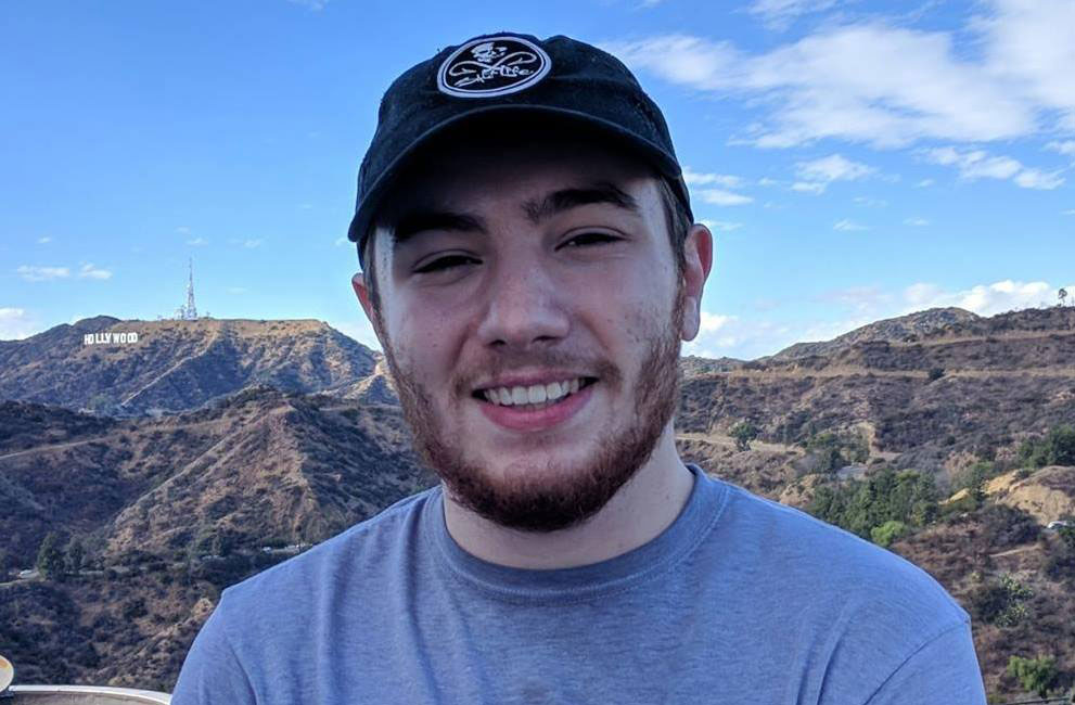 Thomas outside near a mountain range.