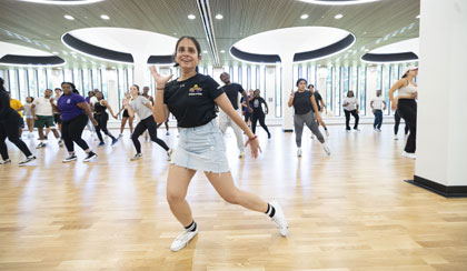 A group of students participating in a zumba class together.