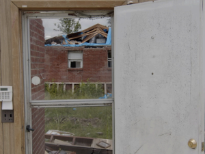 A still from the documentary Muted: Climate Marginalization in America, showing a home badly damaged by a climate-related disaster.