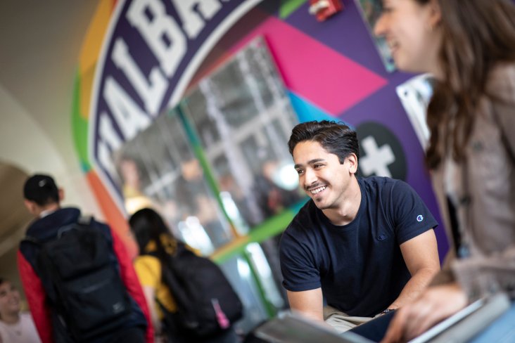 A student smiling in the UAlbany Campus Center.