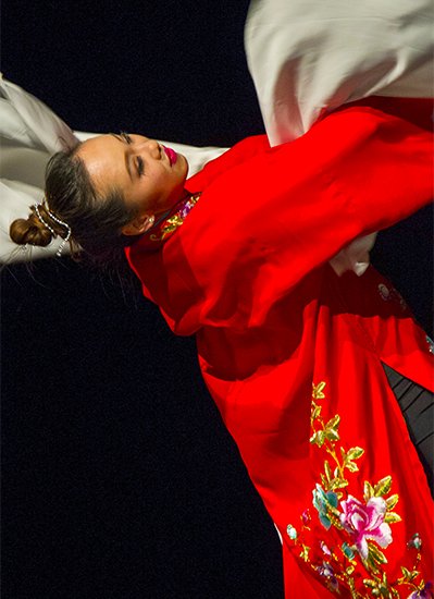 Performer dressed in traditional Chinese gown dances in Chinese New Year performance 2015