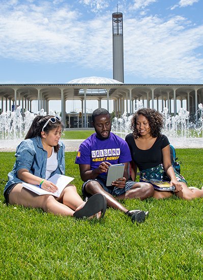 Students sitting on the grass on campus