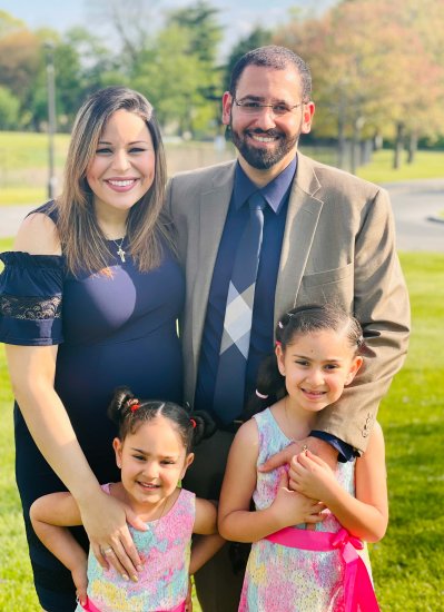 Mena and Mirna Hanna smile at the camera, along with their two daughters.