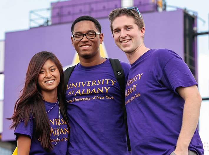 Three students in purple shirts