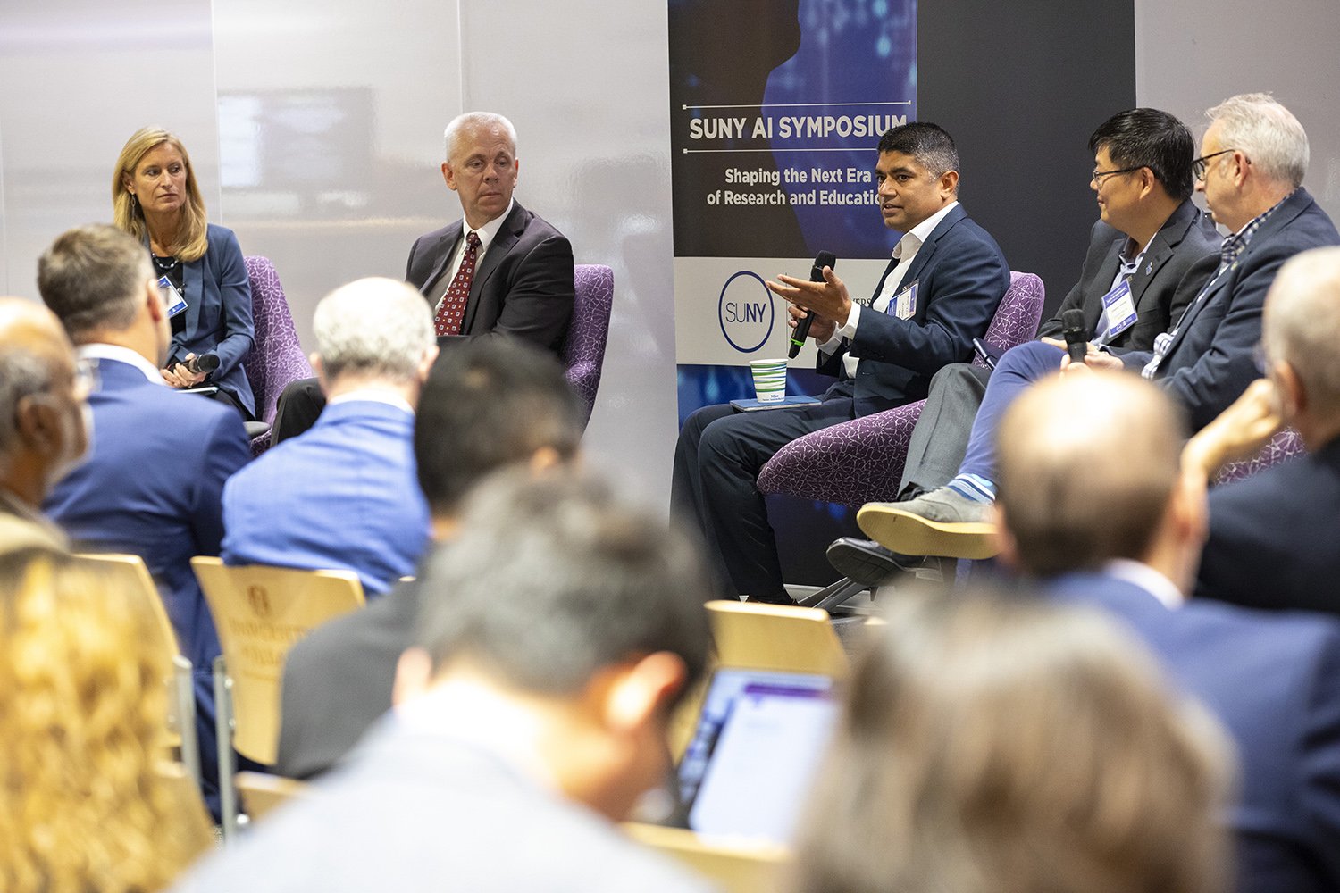 Panelists speak at the SUNY AI Symposium on Oct. 16 at ETEC. (Photo by Patrick Dodson)