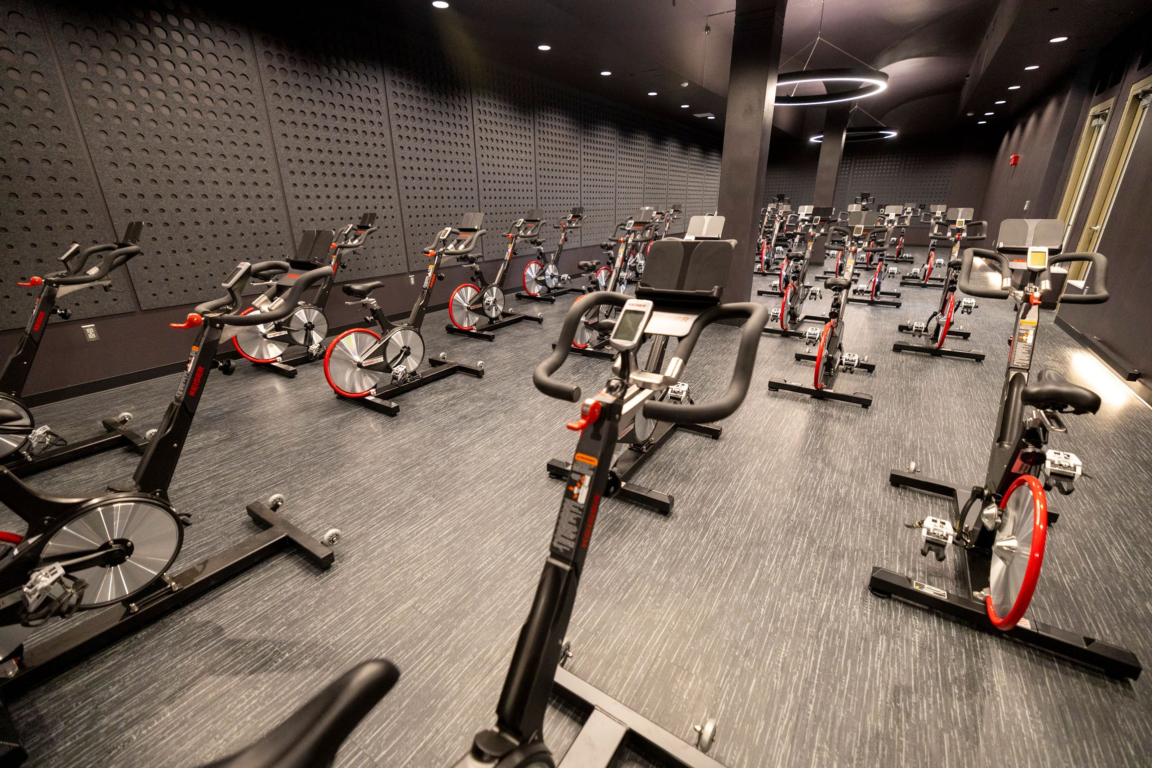 A group exercise room filled with indoor cycling machines.