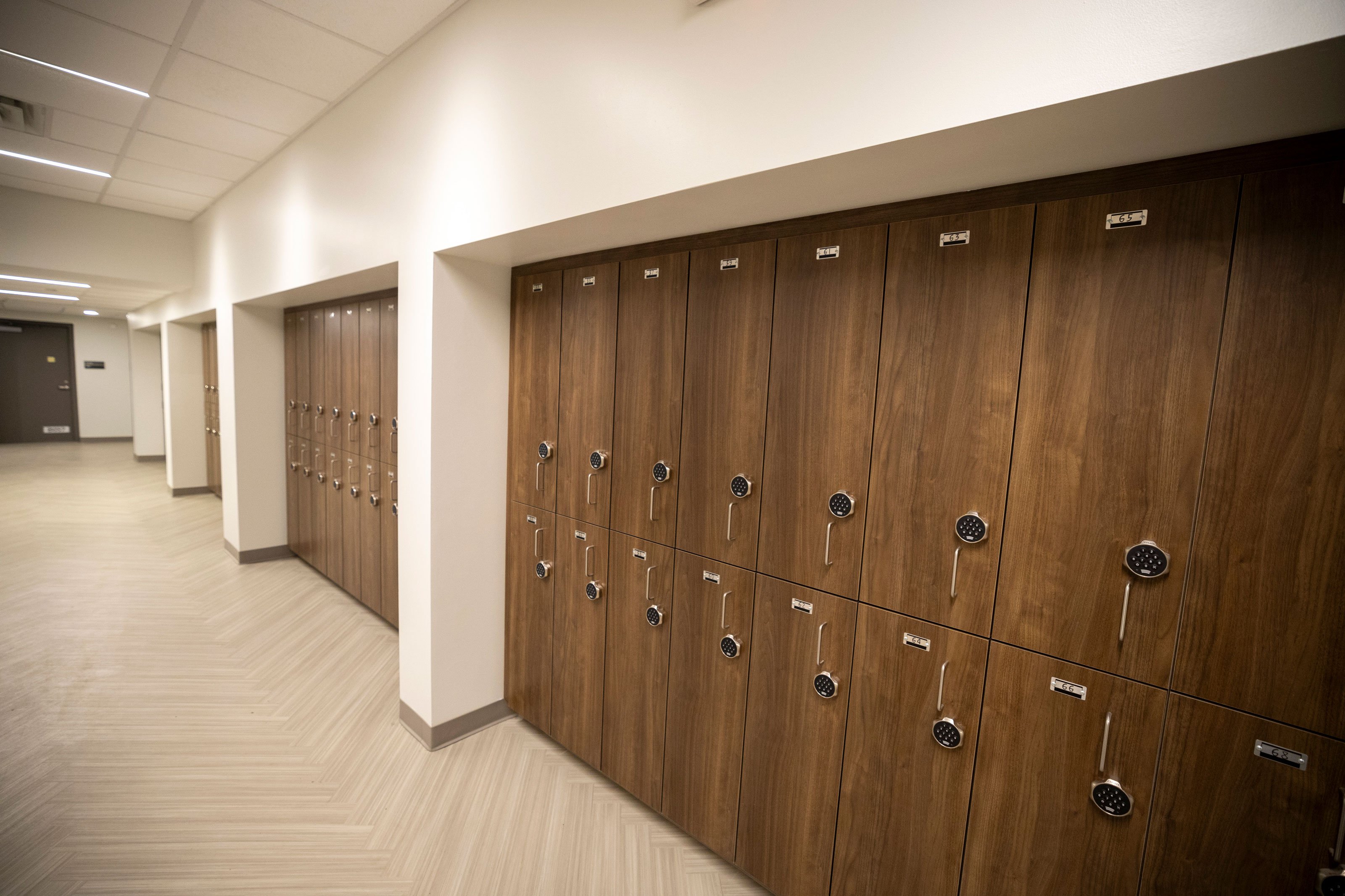 Rows of wooden lockers with keypads.