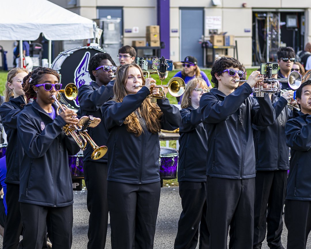 Members of the Marching Great Danes play their instruments at a football pre-game event.