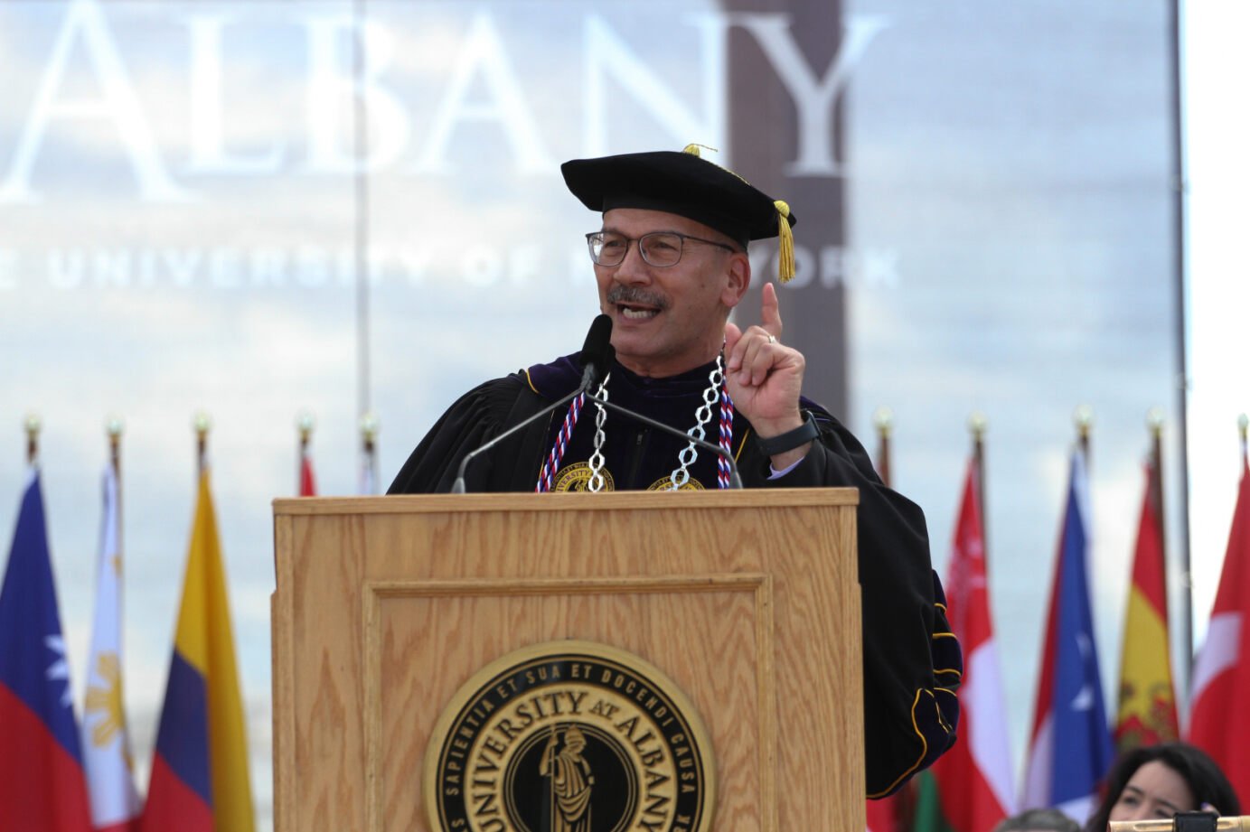 The President at a podium speaking at Academic Convocation.