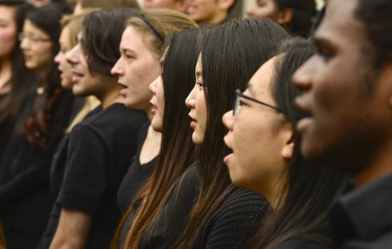 Several musicians stand singing