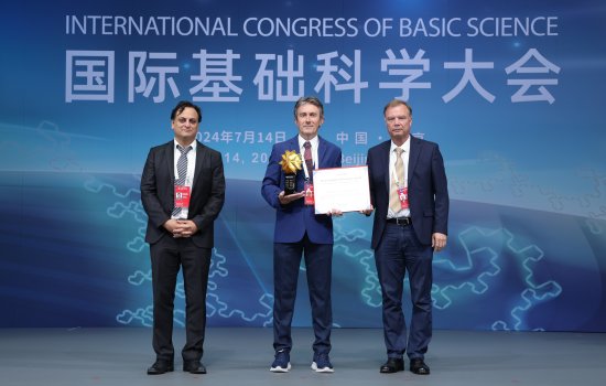 Professor Milas (center) receiving his award, from Babak Haghighat (left) and Nicolai Reshetikhin (right).