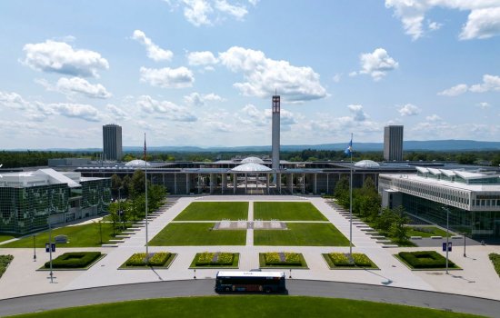 Aerial view of UAlbany's campus showing the entrance plaza with the academic podium behind it.