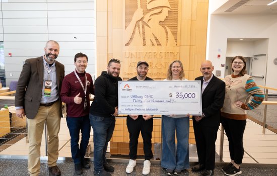 Representatives from CEHC and Wolfjaw stand with a $35,000 scholarship check inside the ETEC atrium.