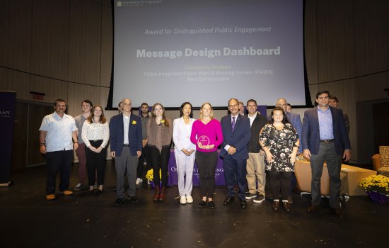 UAlbany researchers accept a campus award for Distinguished Public Engagement.