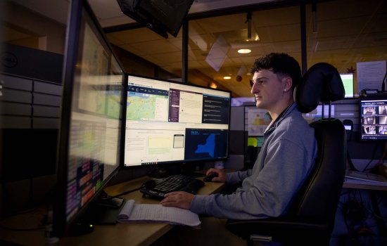 A student reviews multiple computer screens from the New York State Watch Center.