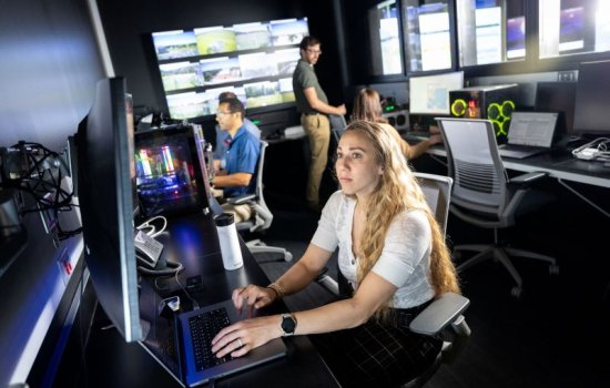 Meteorologist Kara Sulia focuses on a computer screen.