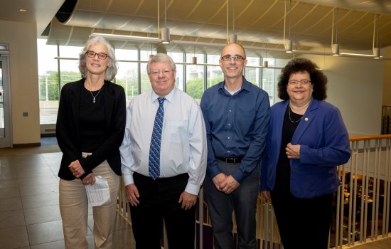 UAlbany faculty Elaine Salisbury, Kevin Knuth and Ryan Torn stand with College of Arts and Sciences Dean Jeanette Altarriba indoors.