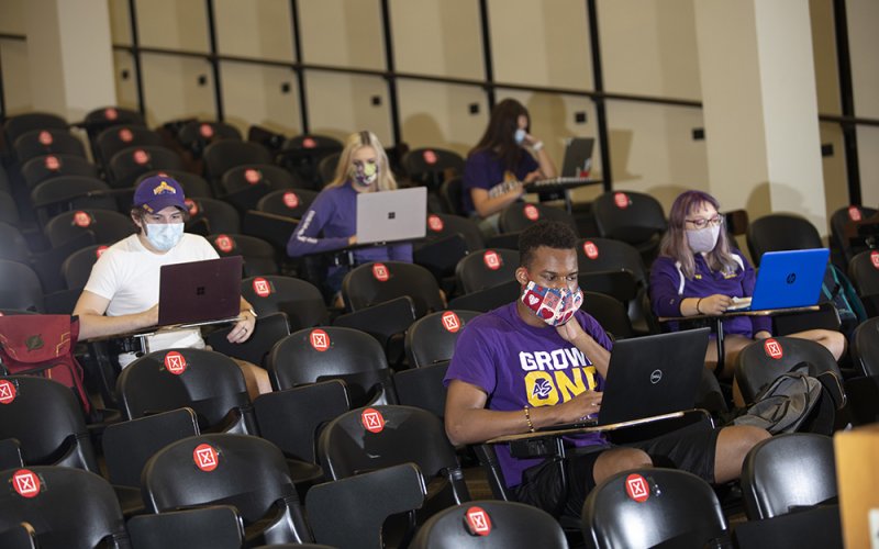 Students wearing PPE in a lecture center