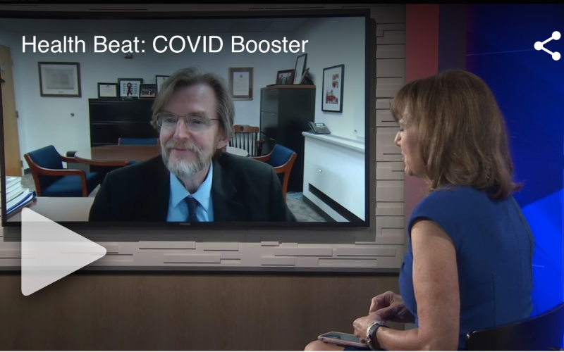 David Holtgrave is on the screen in a news room. The anchor, Benita Zahn, is turned towards the screen to look at him.