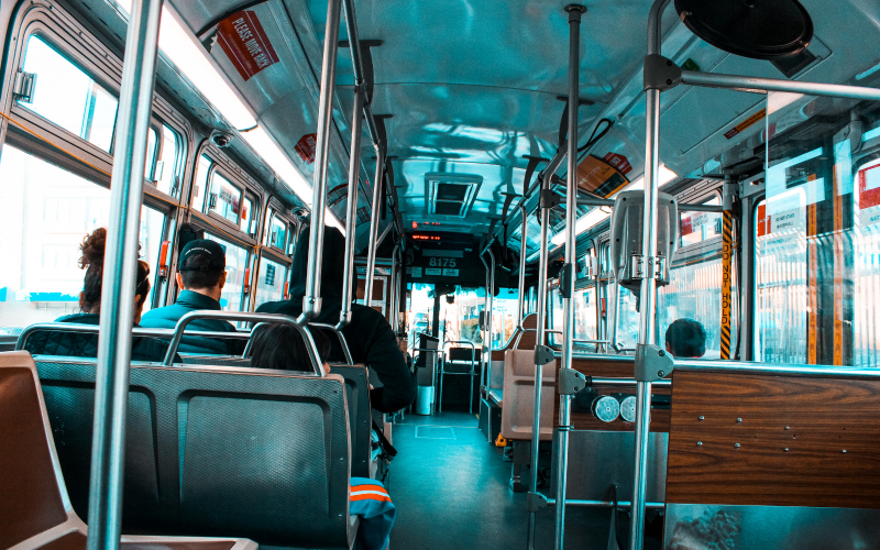 Several people sit inside a public bus.