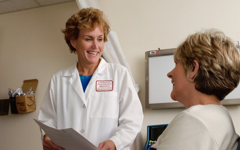 A doctor provides a printed sheet of results to a patient.