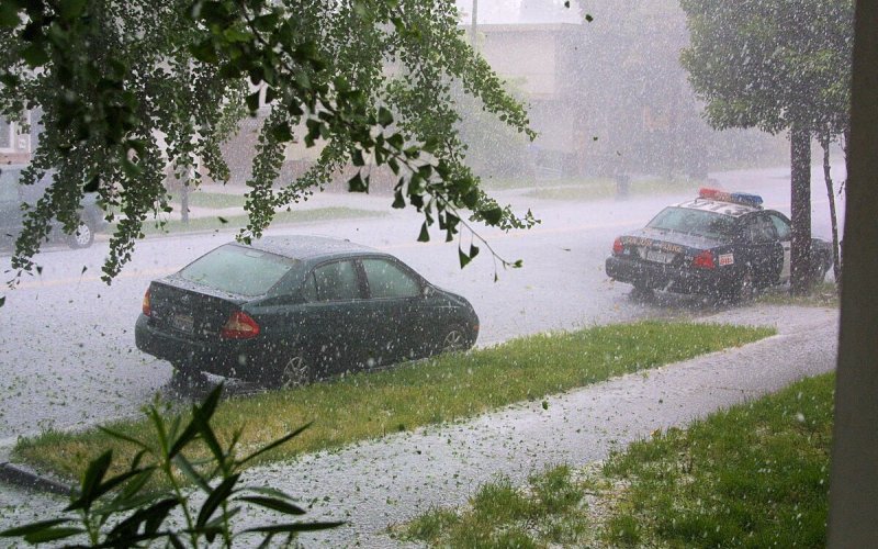 Cars are parked on the side of a road during a hailstorm in San Jose, Calif.