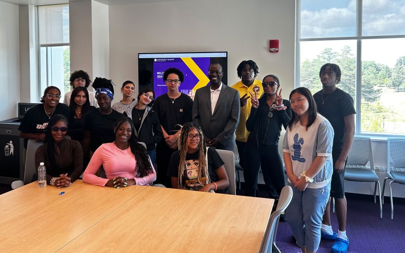 Philip Fields '90, '96 MA, poses with UAlbany students.