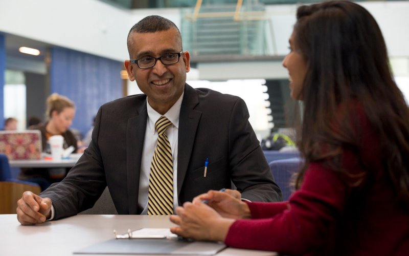 Digital Forensics Chair Sanjay Goel with student