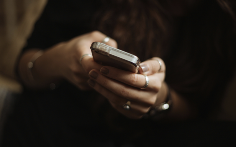 Up-close shot of a woman holding a smartphone in her hands.