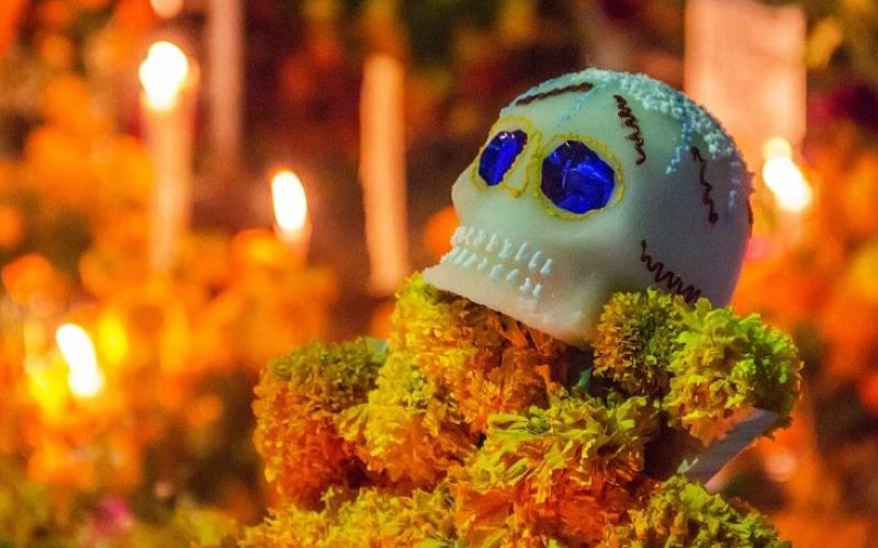 Dia del Los Muertos candles with a decorated scull