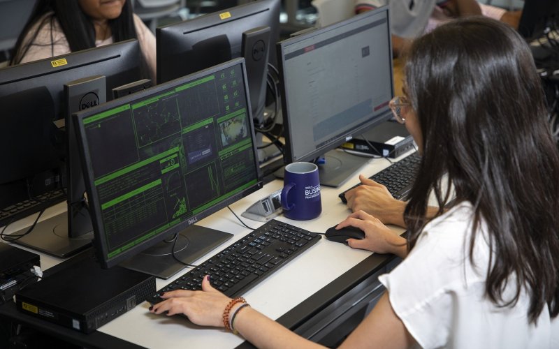 A student works at a terminal in the Digital Forensics lab at the Massry School of Business. (Photo by Patrick Dodson)