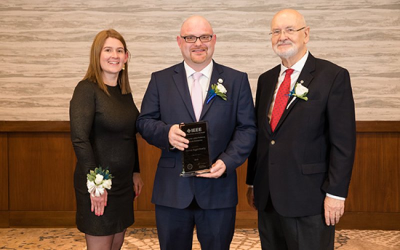 IEEE Vice President for Educational Activities Witold Kinsner and EAB Awards and Recognition Committee Chair Lorena Garcia present Andrew with his award