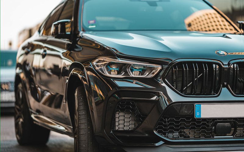 A black Mercedes Benz moving up close at street level